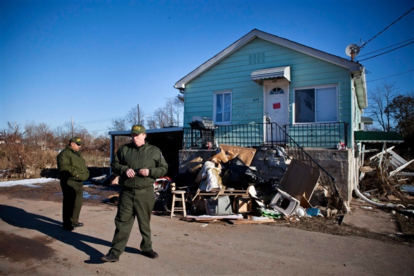 Department of Sanitation Workers survey the Midland Beach neighborhood where many homes are set to be demolished due to Hurricane Sandy in Staten Island, New York November 9, 2012. Photo from NBC News. 