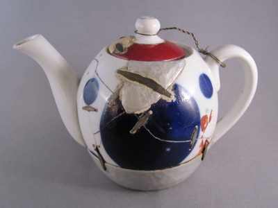 Eastern European teapot, c.1925. "No part of this poor teapot has escaped damage, making it by far the most altered piece in my collection. There are 18 metal support staples, a replaced hand-hammered tin base, a large tin patch on one side, a mended chip on the lid grafted from another lid entirely, and a wire tether holding the lid in place. The  numerous metal staples (aka rivets) appear to be machine made and are reinforced with cement."