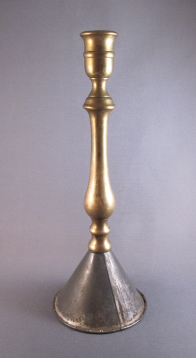 Brass candle holder, c.1880. The base looks as if it were made from a funnel. 