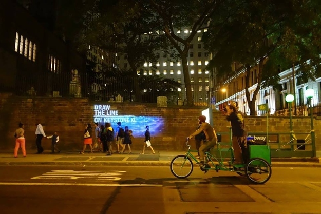 A high water line showing where Wall Street will be flooded due to climate change, projected by The Illuminator collective. Photo via Lucky Tran.