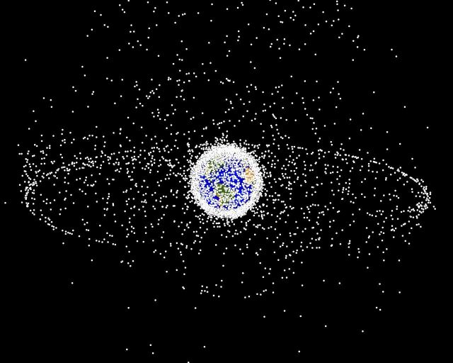 Debris plot by NASA. A computer-generated image of objects in Earth orbit that are currently being tracked. Approximately 95% of the objects in this illustration are orbital debris, i.e., not functional satellites. The dots represent the current location of each item. The orbital debris dots are scaled according to the image size of the graphic to optimize their visibility and are not scaled to Earth. Public domain image by NASA. 