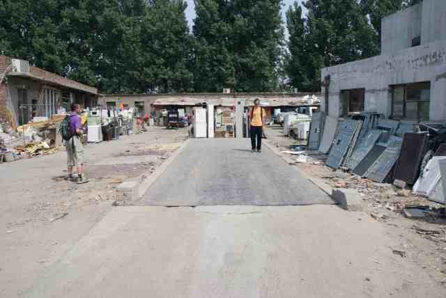 Truck weighing scale at discarded electronics market in Beijing, China. Note remains of flat screen TVs at right. Photo credit: Josh Lepawsky, 2013