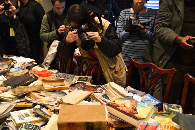 Press photographing damaged books at the conference announcing a lawsuit against the City of New York (Photo: M. Oman-Reagan)
