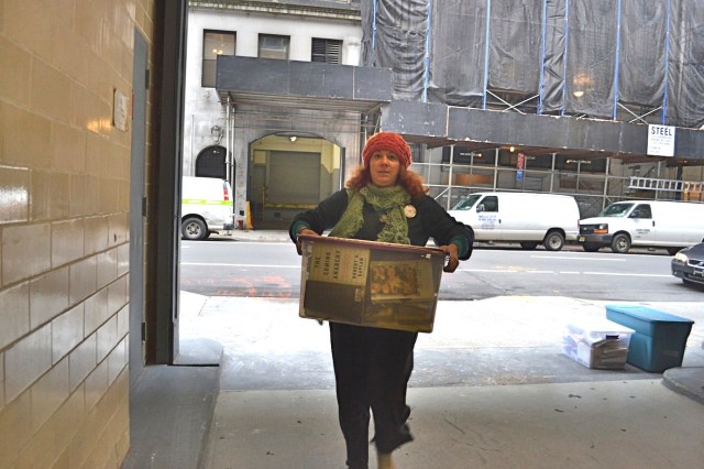 Librarian carrying books into Norm’s office. (photo: M. Oman-Reagan)