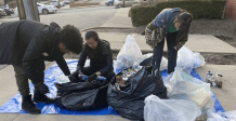 Young adults searching through clear and opaque garbage bags