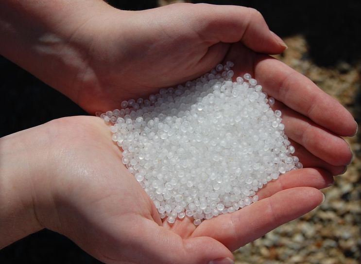 image of tiny white plastic pellets created by and used for industrial processes